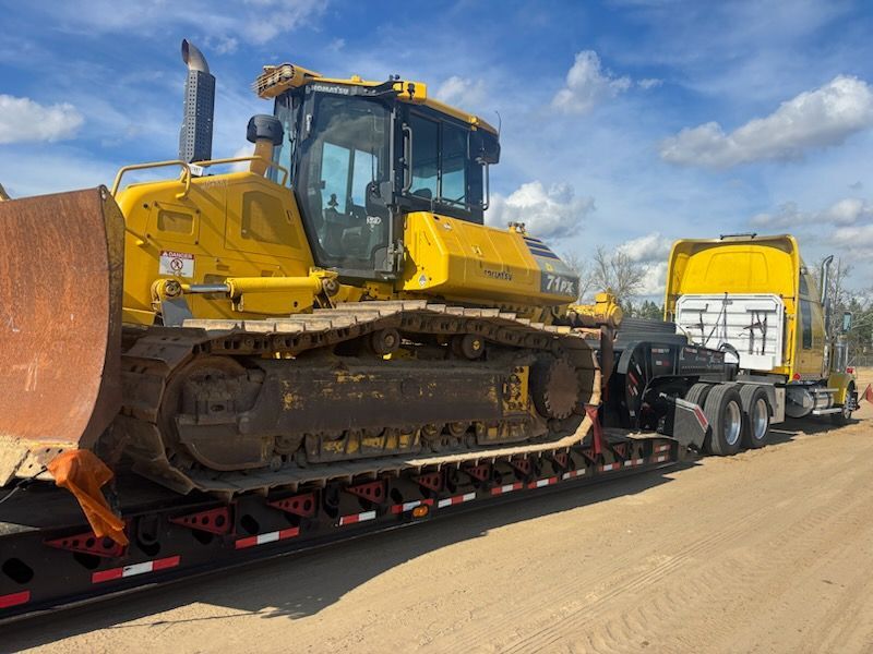 Komatsu bulldozer loaded on a lowboy trailer