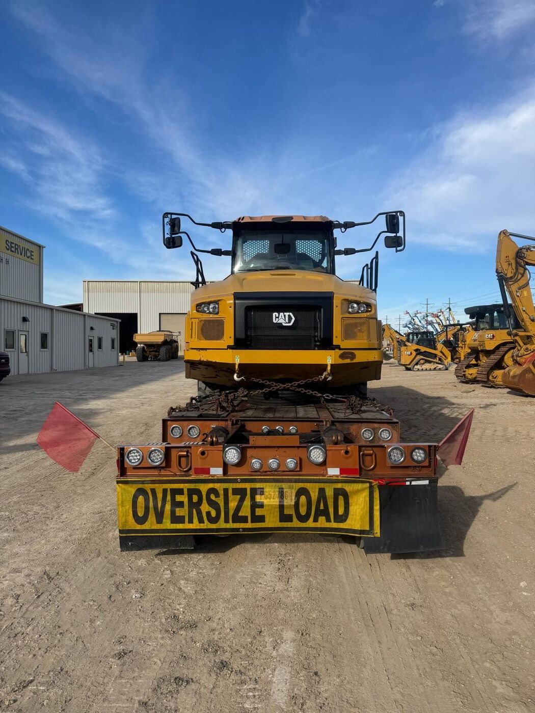CAT articulated dump truck with oversize load banner