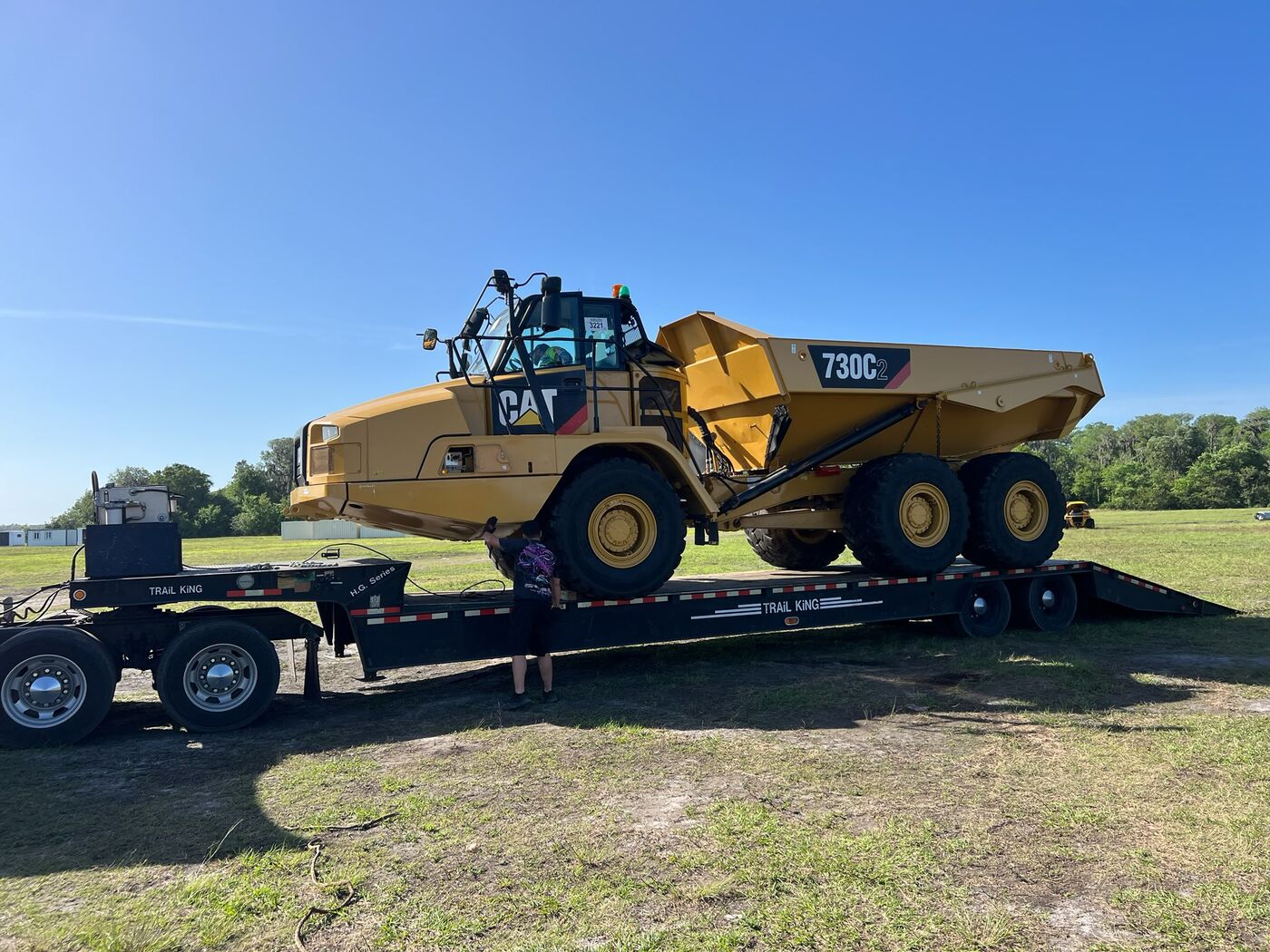 CAT 730C2 articulated dump truck loaded on a lowboy trailer